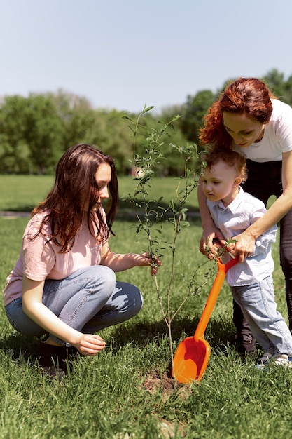 Lesbian couple spending time with their kid in the park