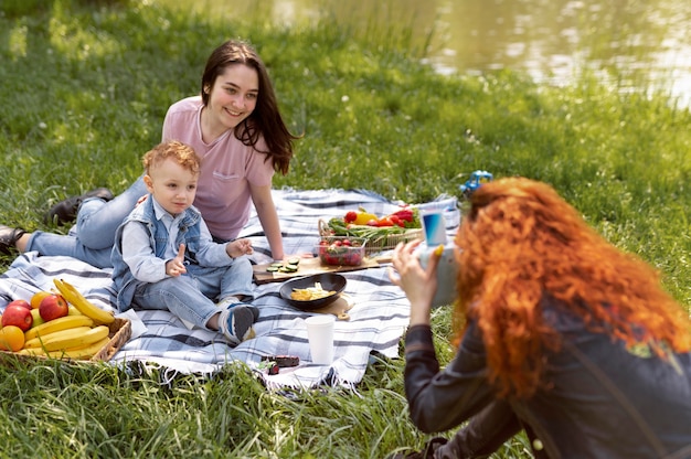 Free photo lesbian couple spending time with their kid