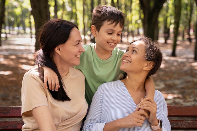 Lesbian couple with their son spending time together outdoors