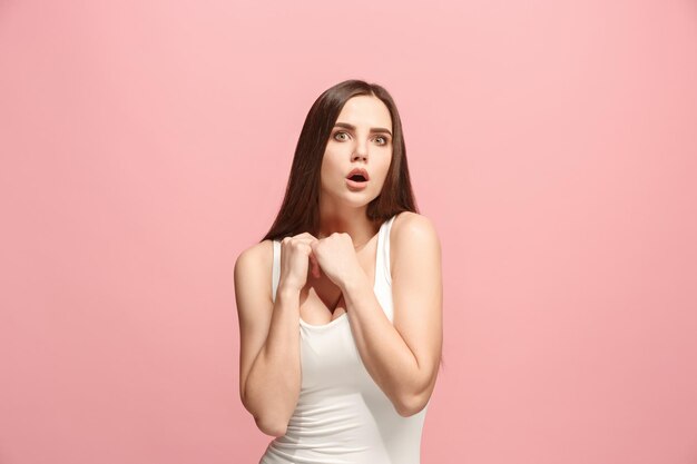 Let me think. Doubt concept. Doubtful pensive woman with thoughtful expression making choice. Young emotional woman. Human emotions, facial expression concept. Front . Studio. Isolated on trendy pink
