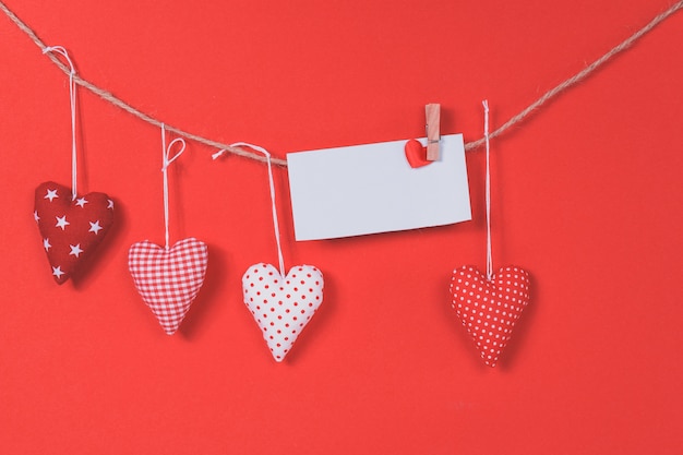 Letter hanging on a rope with hearts