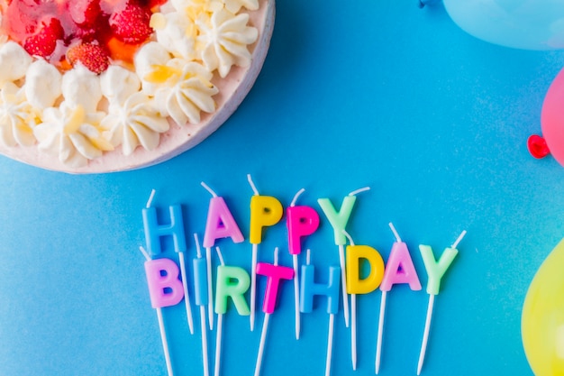 Letter-shaped candles near cake