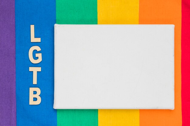 LGBT abbreviation and white paper sheet on colorful background
