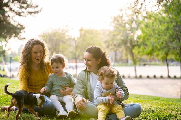 Foto gratuita famiglia lgbt all'aperto nel parco con il cane