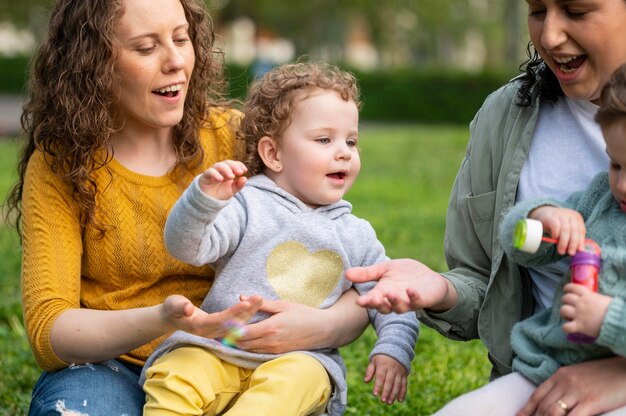Lgbt mothers outdoors in the park with their children