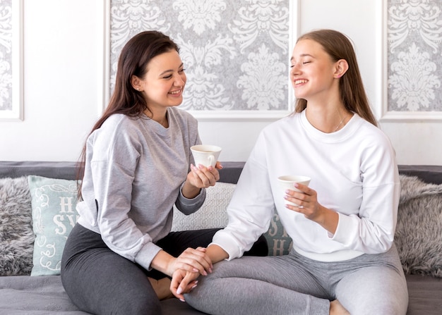 Free photo lgtb couple smiling on the sofa