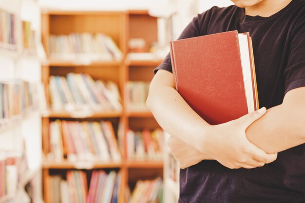 In the library - Young girl student with books working in a high school library. 