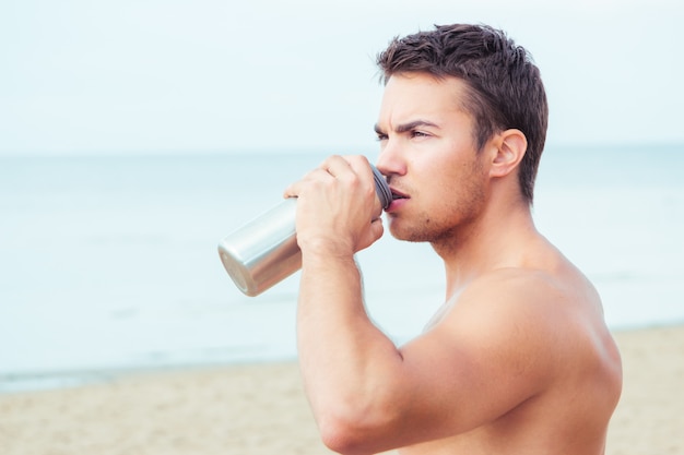 Lifeguard on the beach drinking water