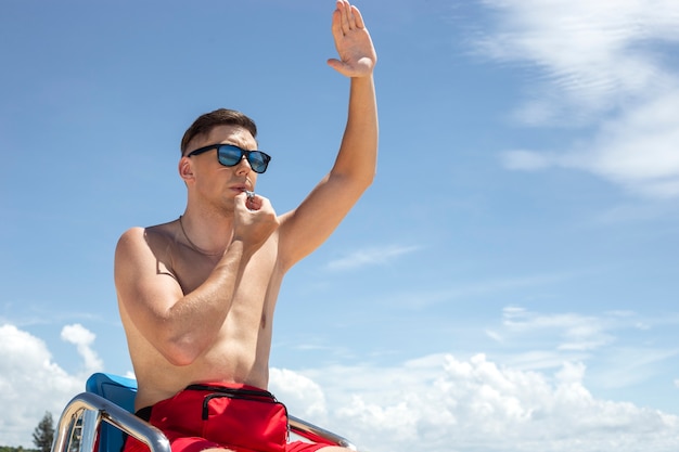 Lifeguard sitting on chair low angle