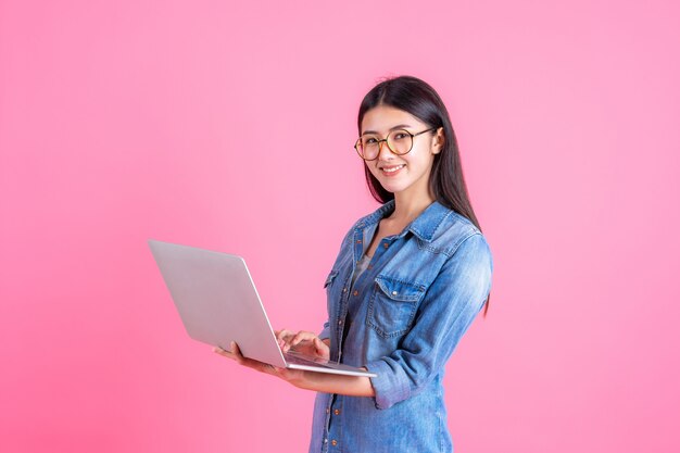 lifestyle business people using laptop computer on pink