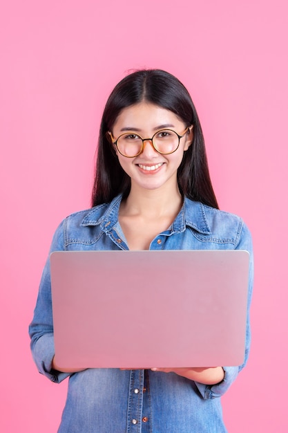 lifestyle business people using laptop computer on pink