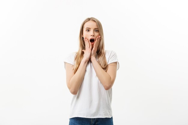 Lifestyle Concept: Portrait of a scared frightened girl standing and surprising facial expression isolated over white background.