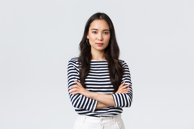 Lifestyle, people emotions and casual concept. Confident nice smiling asian woman cross arms chest confident, ready to help, listening to coworkers, taking part conversation