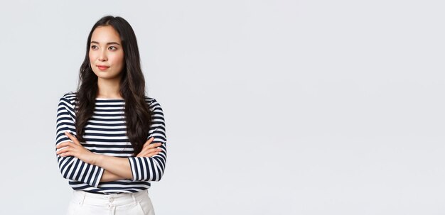 Lifestyle people emotions and casual concept Confident nice smiling asian woman cross arms chest confident ready to help listening to coworkers taking part conversation