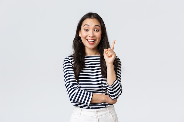 Lifestyle, people emotions and casual concept. Excited smart and creative asian female coworker have suggestion, add idea, raising index finger to say thought or plan, standing white background