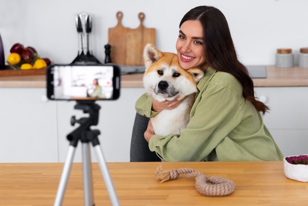 Free photo lifestyle of person creating content with their pet