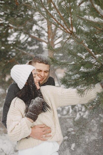 Lifestyle shot of couple walking in snowy forest