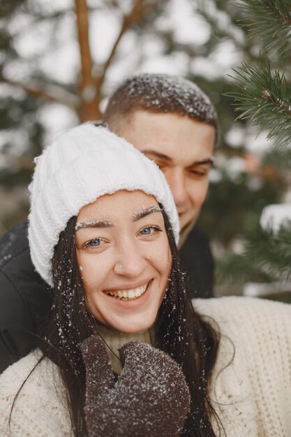 Lifestyle shot of couple walking in snowy forest