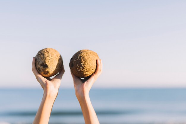 Lifting two coconuts in the air