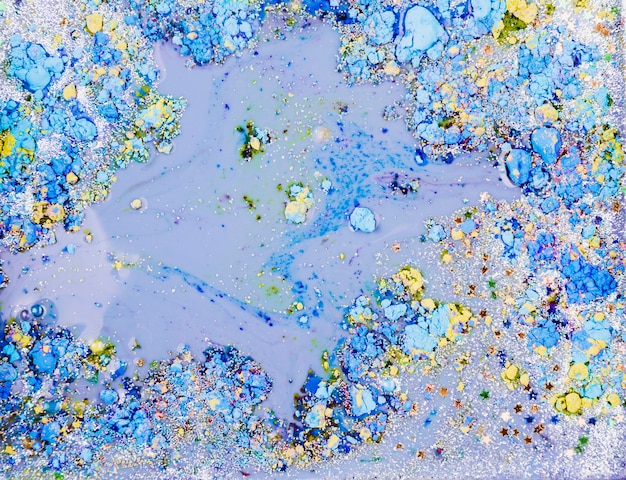 Free photo light blue liquid mixing with ornamental stars and bright crumbs