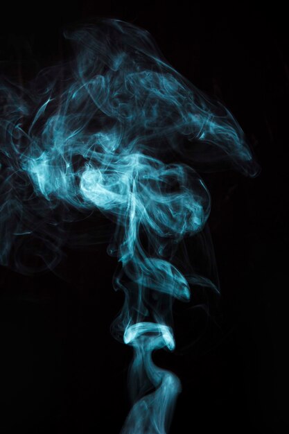 Light blue smoke on black background