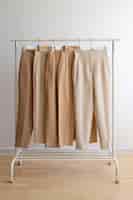 Free photo light brown beige pants on hangers