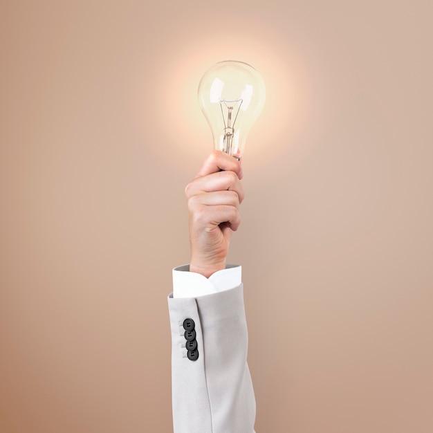 Free photo light bulb creative business idea symbol held by a hand