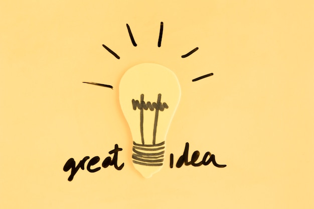 Free photo light bulb with great idea text on yellow background