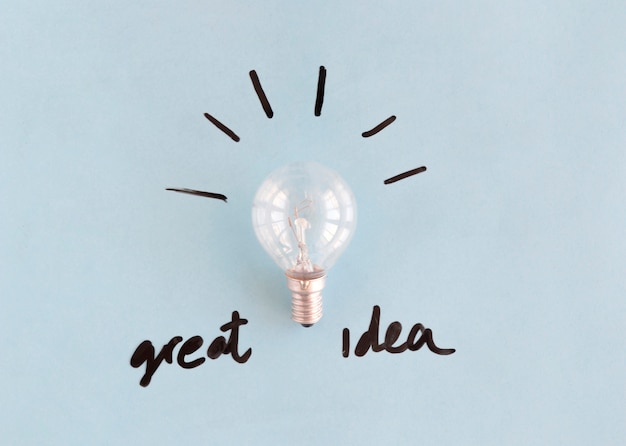 Light bulb with great idea word on blue background