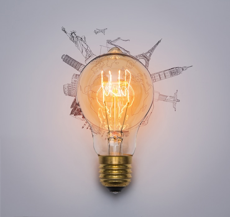 Free Photo light bulb with monuments drawn around
