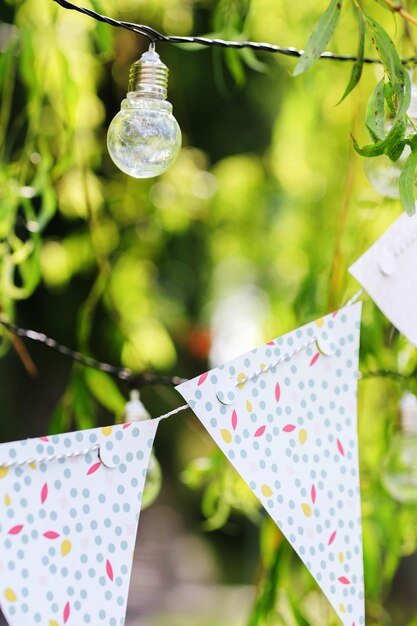 Light bulbs and garland hang on branches