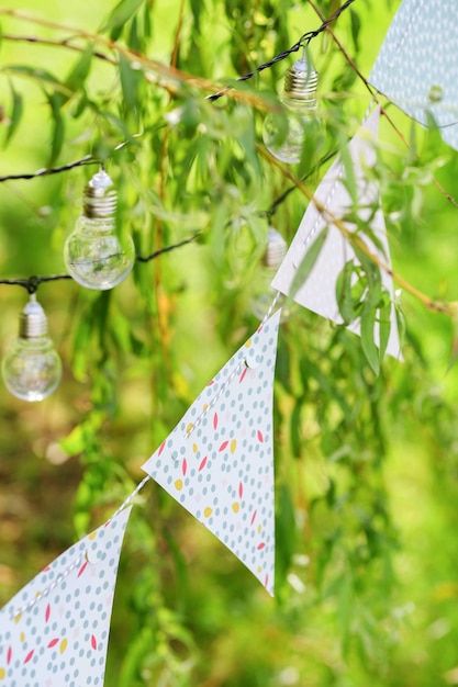 Light bulbs and garland hang on branches