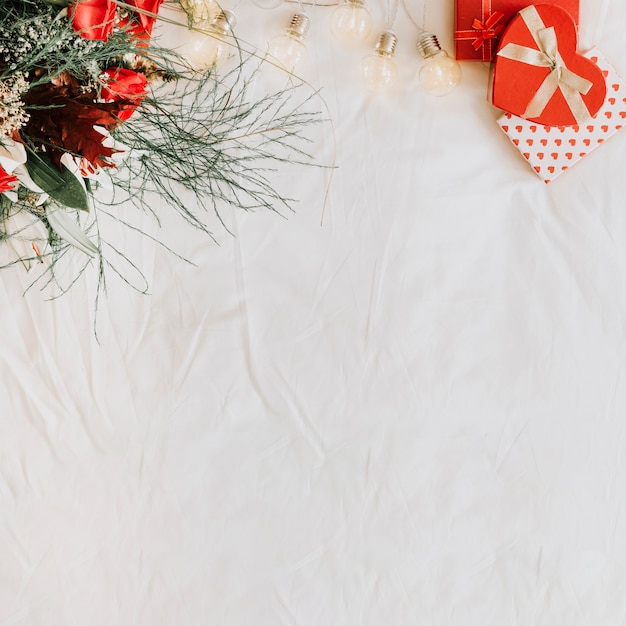 Free photo light garland between presents and bouquet