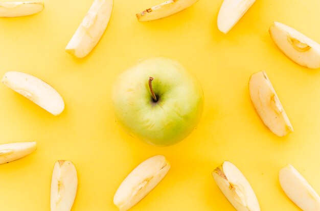 Light green apple among apple pieces