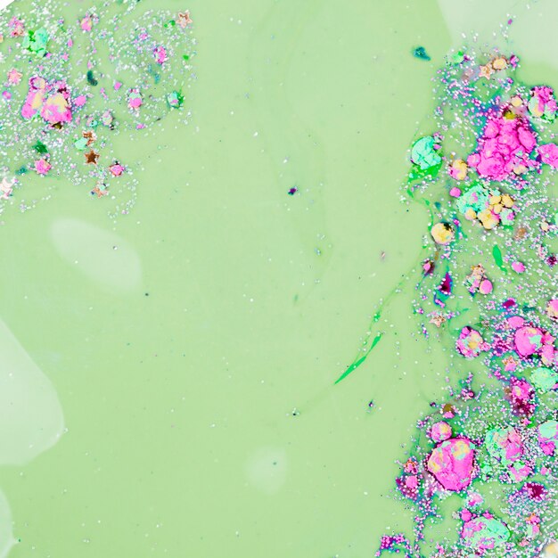 Light green liquid mixing with ornamental stars and bright bits