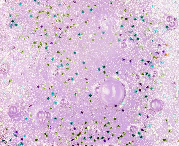 Light purple liquid with blobs and ornamental stars