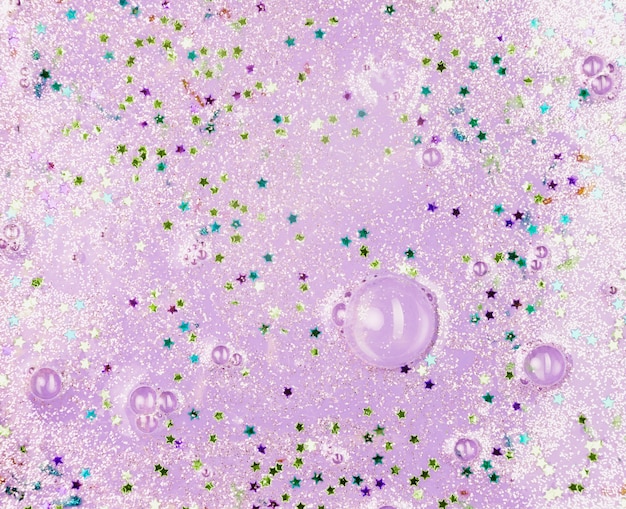 Light purple liquid with blobs and ornamental stars