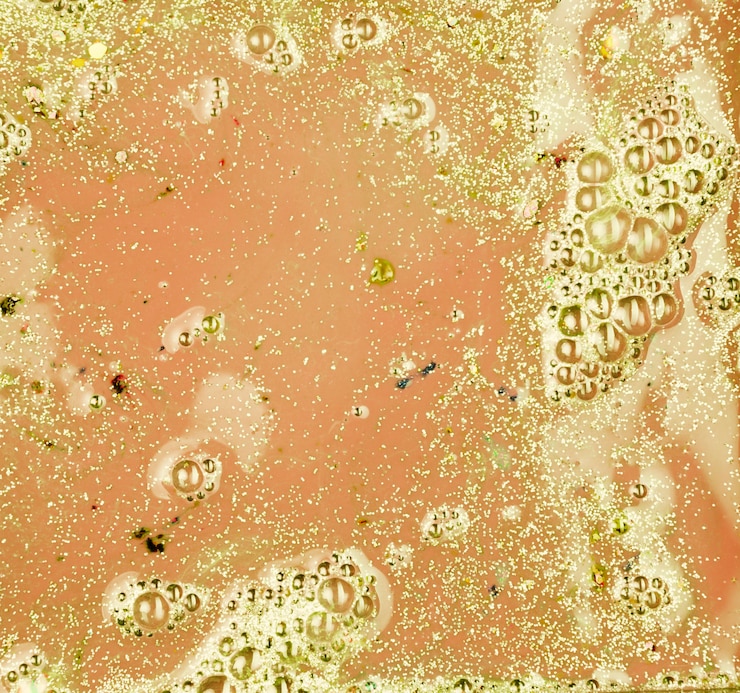Free Photo light rose liquid with gold crumbs