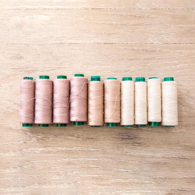 Light shade of spools on wooden backdrop