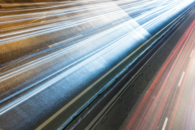 light trails on city street with cityscape