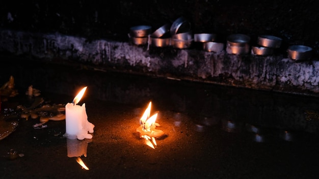 Free photo lighted candles in a dark space religious concept