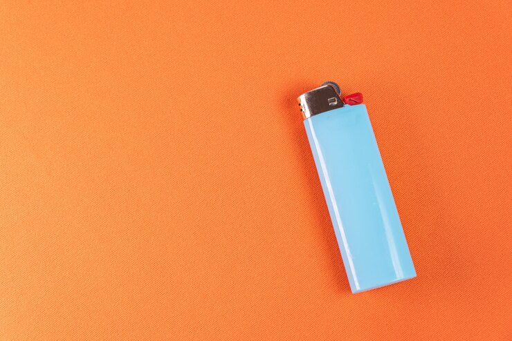 Free Photo lighter on the orange background - macro detail