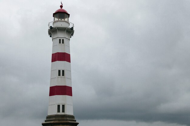 Lighthouse against dark overcast sky