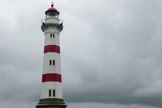 Lighthouse against dark overcast sky