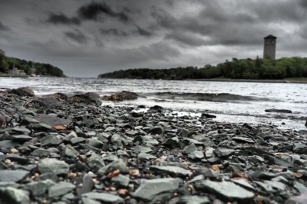 Lighthouse by a lake captured on a cloudy day - concept: mysterious