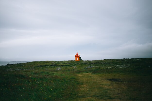 Lighthouse at seashore of Iceland, summer time, sunny day