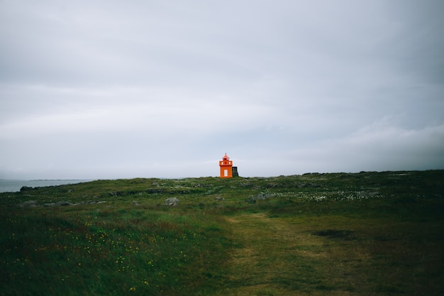 Lighthouse at seashore of Iceland, summer time, sunny day