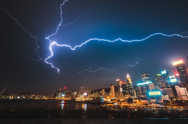 Lightning strike over a modern urban city at night