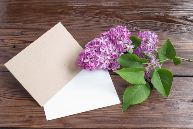 Lilac flowers on wooden table.