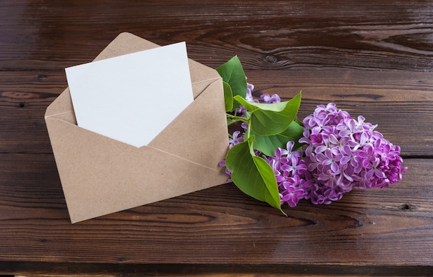 Lilac flowers on wooden table.